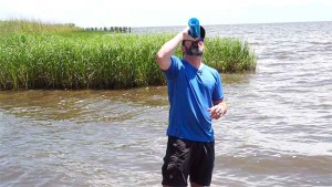 Clint drinks Mississippi River water from a LifeStraw GO Bottle during 50 Campfires Field Trip: Great River Road.