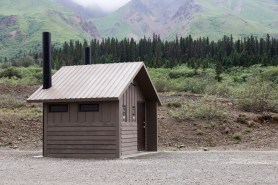 hiker carrying barrel